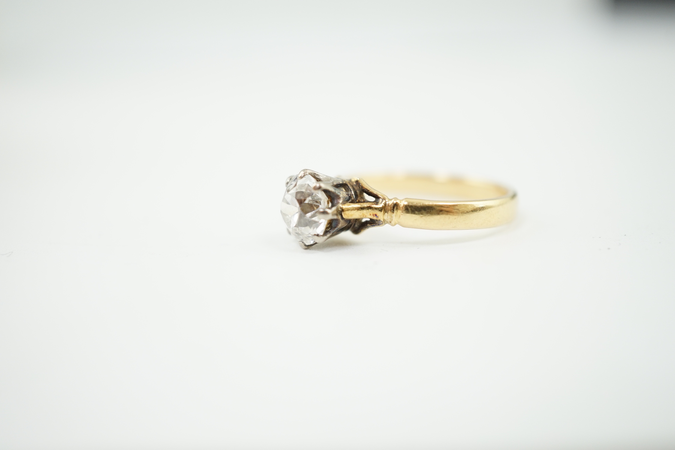 A gold and solitaire diamond set ring